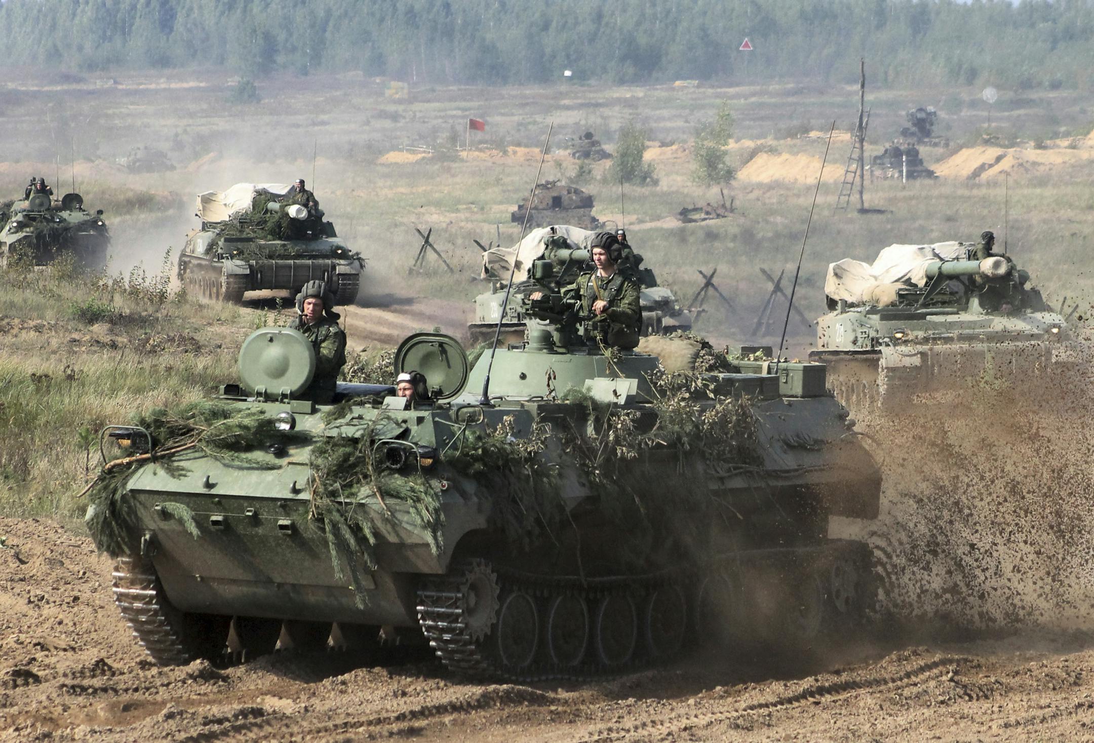 In this photo taken on Monday, Sept. 11, 2017, Belarusian army vehicles drive preparing for war games at an undisclosed location in Belarus. Russia and Belarus are holding a massive war games, Zapad 2017, that due to start on Thursday near the borders of Poland, Estonia, Latvia and Lithuania. (Vayar Military Agency photo via AP)