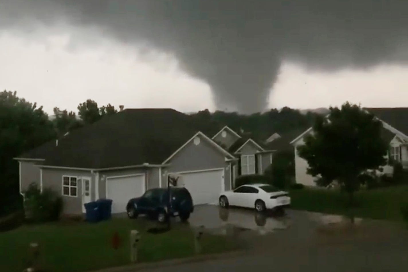 This still image taken from video provided by Chris Higgins shows a tornado in Carl Junction, Mo., on Wednesday. Three people were killed in Missouri.