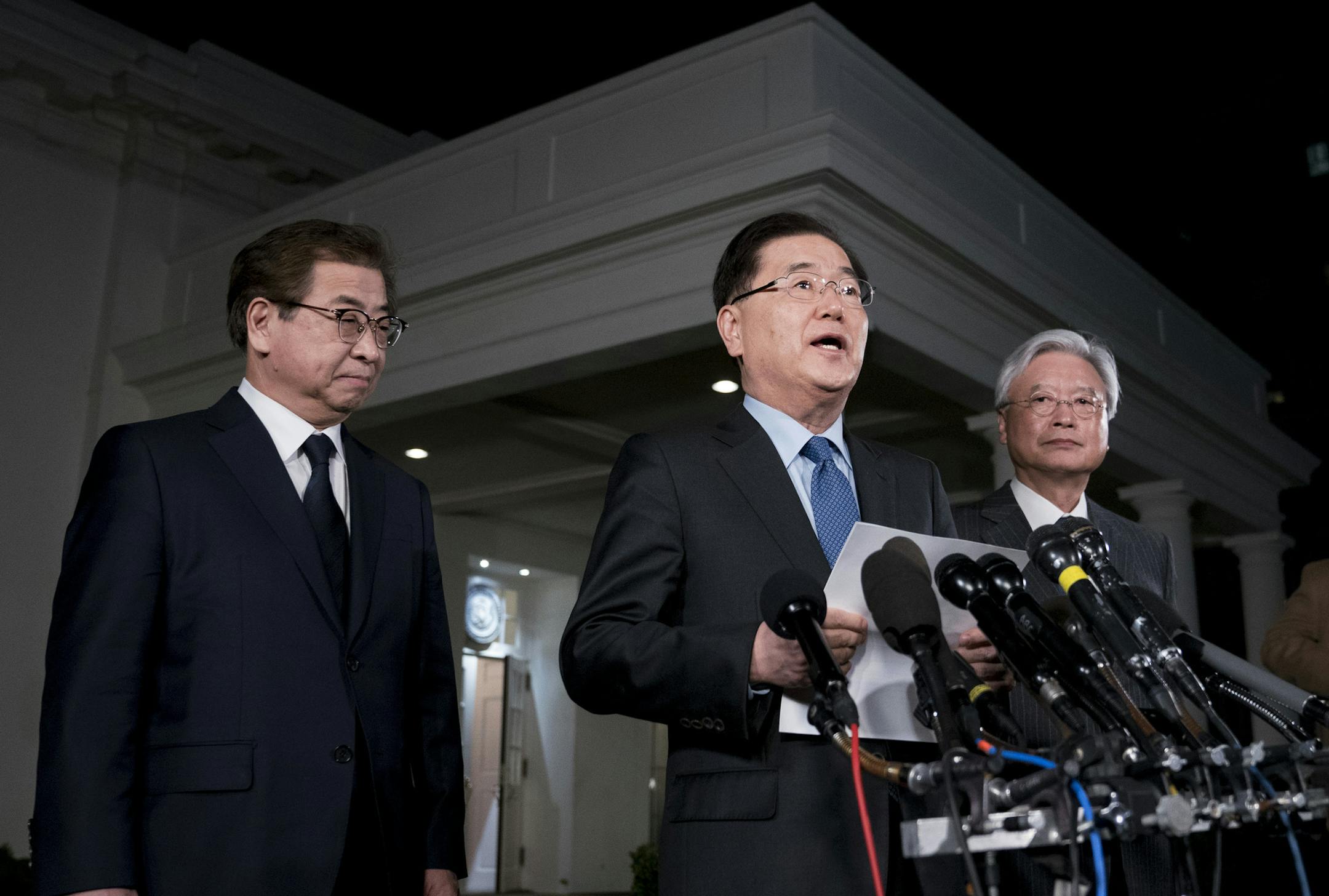 South Korean national security director Chung Eui-yong, center, speaks to reporters at the White House in Washington, Thursday, March 8, 2018, as intelligence chief Suh Hoon, left and Cho Yoon-je, the South Korea ambassador to United States, listen. President Donald Trump has accepted an offer of a summit from the North Korean leader and will meet with Kim Jong Un by May, Chung said in a remarkable turnaround in relations between two historic adversaries. (AP Photo/Andrew Harnik)