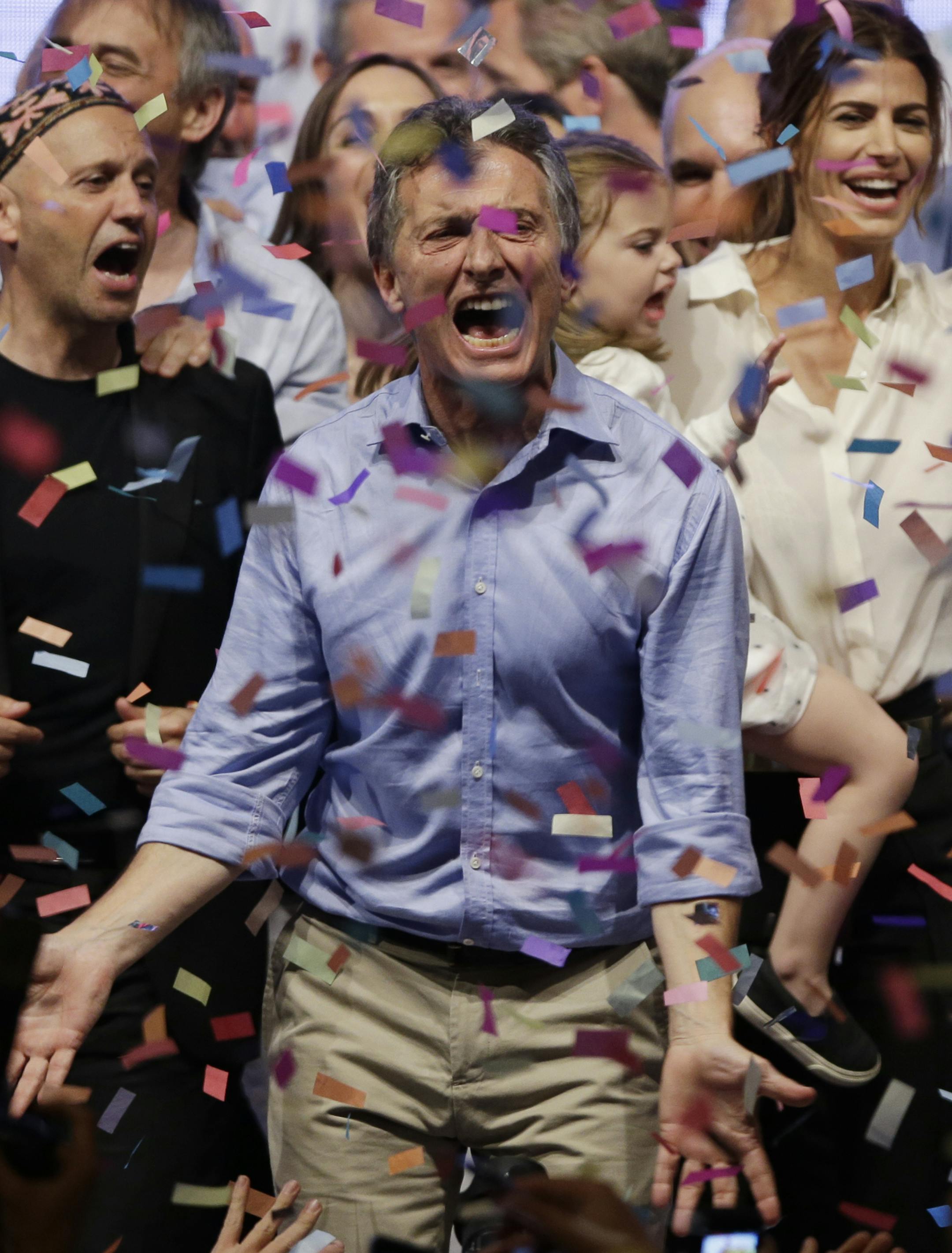 Opposition presidential candidate Mauricio Macri and his wife Juliana Awada, back right, celebrate after winning a runoff election in Buenos Aires, Argentina, Sunday, Nov. 22, 2015. Macri won Argentina's historic runoff election against ruling party candidate Daniel Scioli, putting an end to the era of President Cristina Fernandez, who along with her late husband dominated Argentine politics for 12 years. (AP Photo/Ricardo Mazalan)