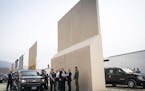 FILE -- President Donald Trump views border wall prototypes in the border neighborhood of Otay Mesa near San Diego, March 13, 2018. "The president sti