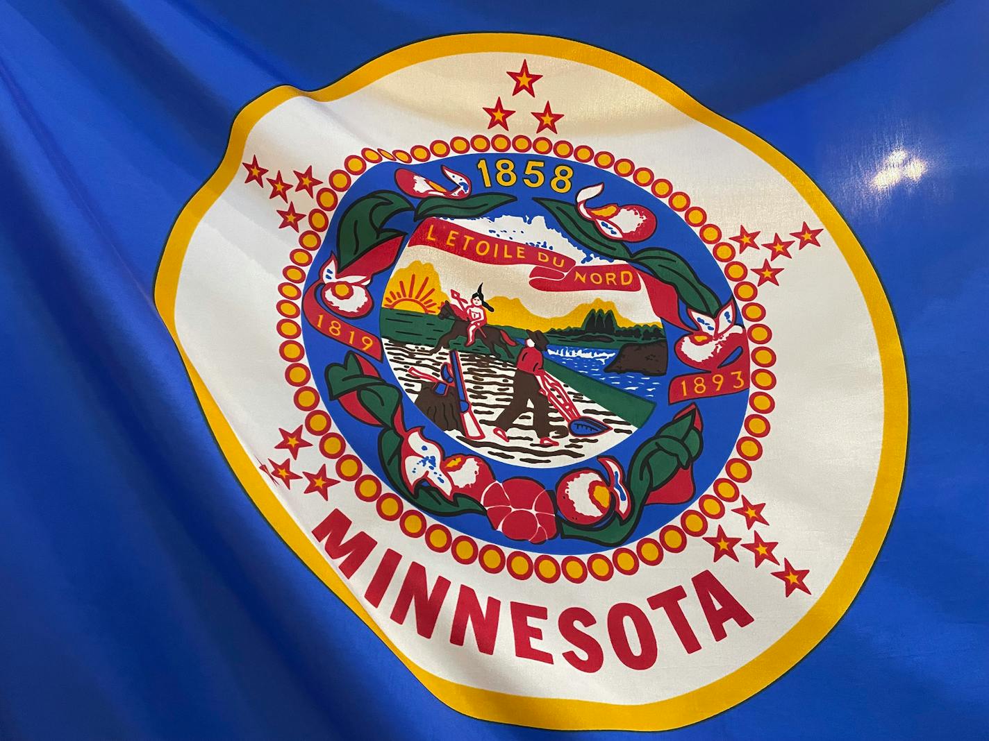 The Minnesota state flag is seen as displayed in the State Capitol building rotunda on Thursday, March 24, 2022, in St. Paul, Minn. Minnesota lawmakers are resurrecting an effort to redesign the state's flag and seal, which proponents say are indistinct compared with other U.S. states and feature imagery that is offensive to Native Americans. (Mohamed Ibrahim/Report for America via AP)