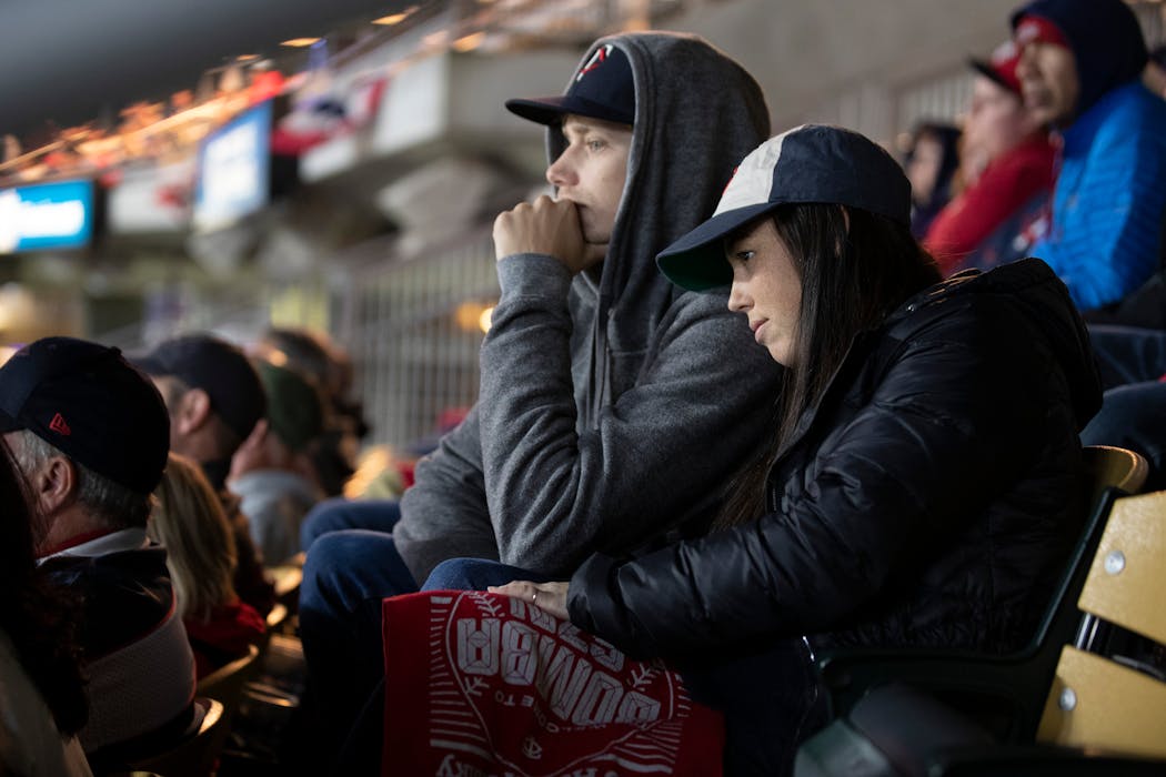 Twins fans Chris Peterson and Megan Brown found it hard to watch the Twins in the 8th inning during the third game of the ALDS at Target Field. 