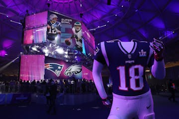 A Patriots mannequin for fans to pose in stood near the line for photos of the Vince Lombardi Trophy at the Super Bowl Experience.