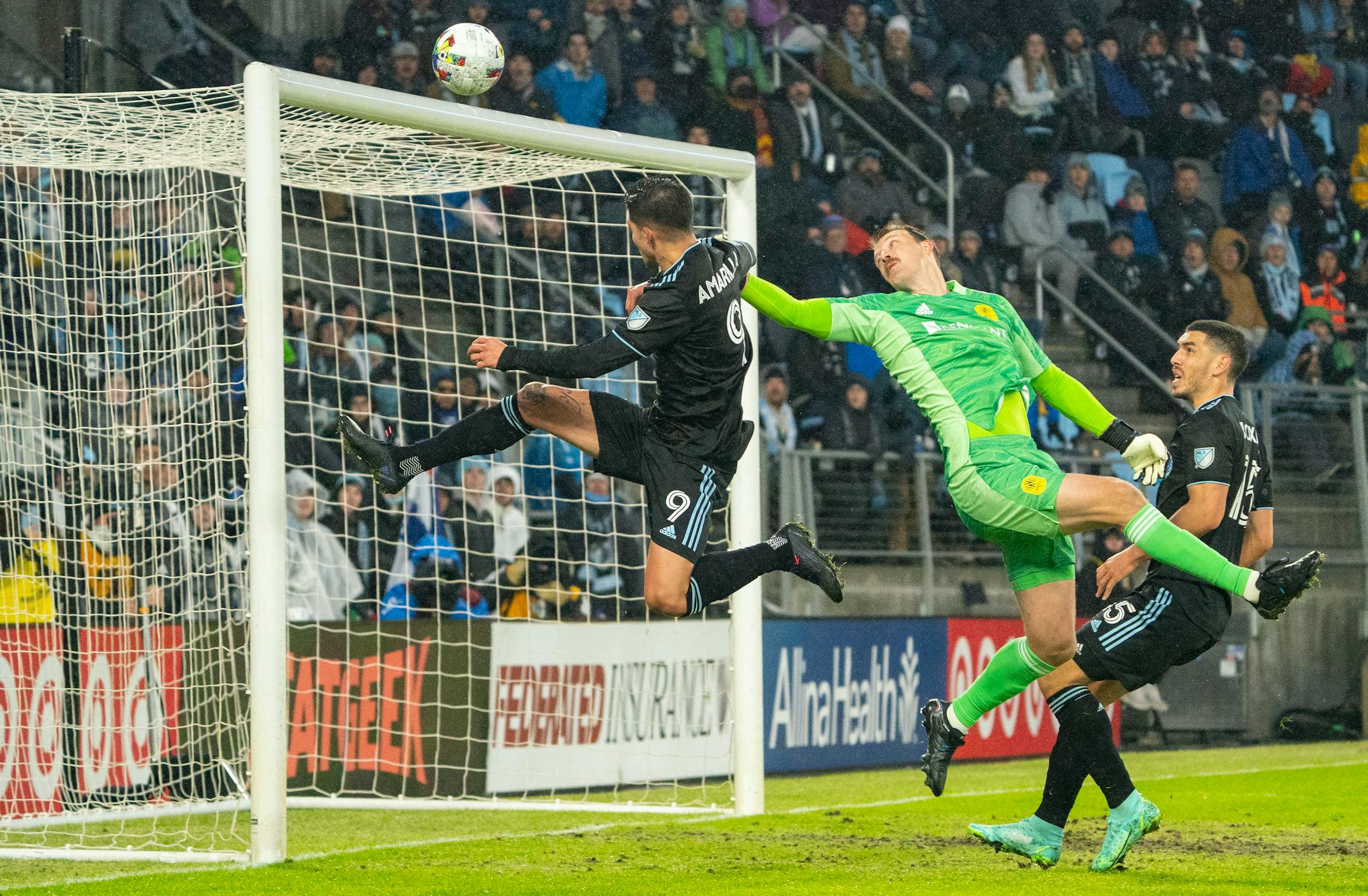 Nashville SC goalkeeper Joe Willis makes a save while Minnesota United forward Luis Amarilla crashes the net in the first half Saturday.