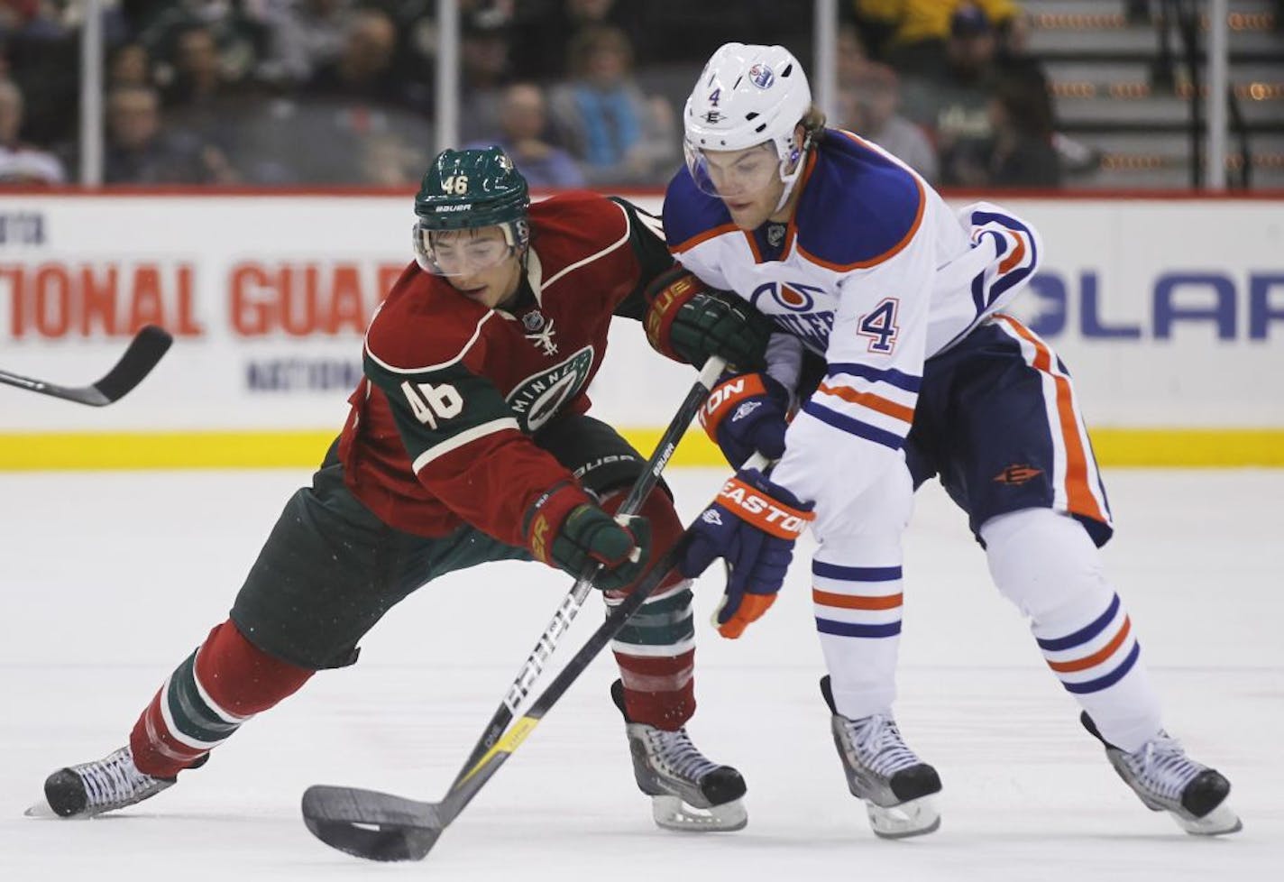 At the Wild game against the Oilers at the Xcel Center in St. Paul, Wild Jared Spurgeon(46) battles for the puck with Taylor Hall(4) during the first period.