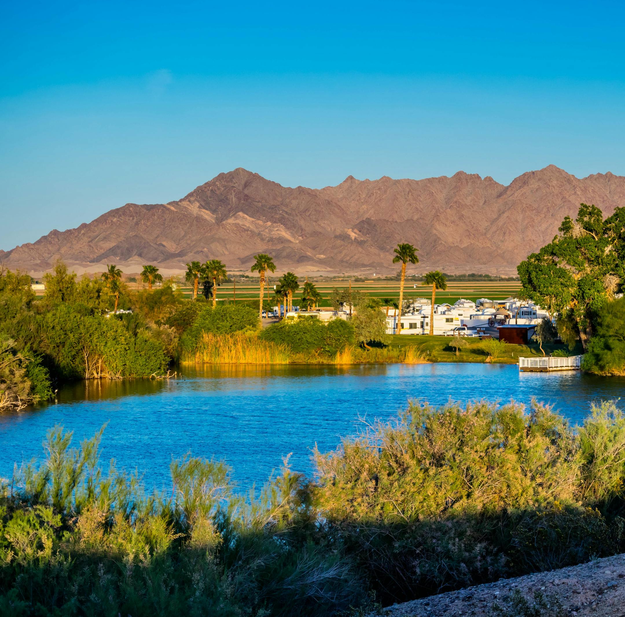 A large refreshing lake with a background silhouette of the mountain in Southwest Arizona
