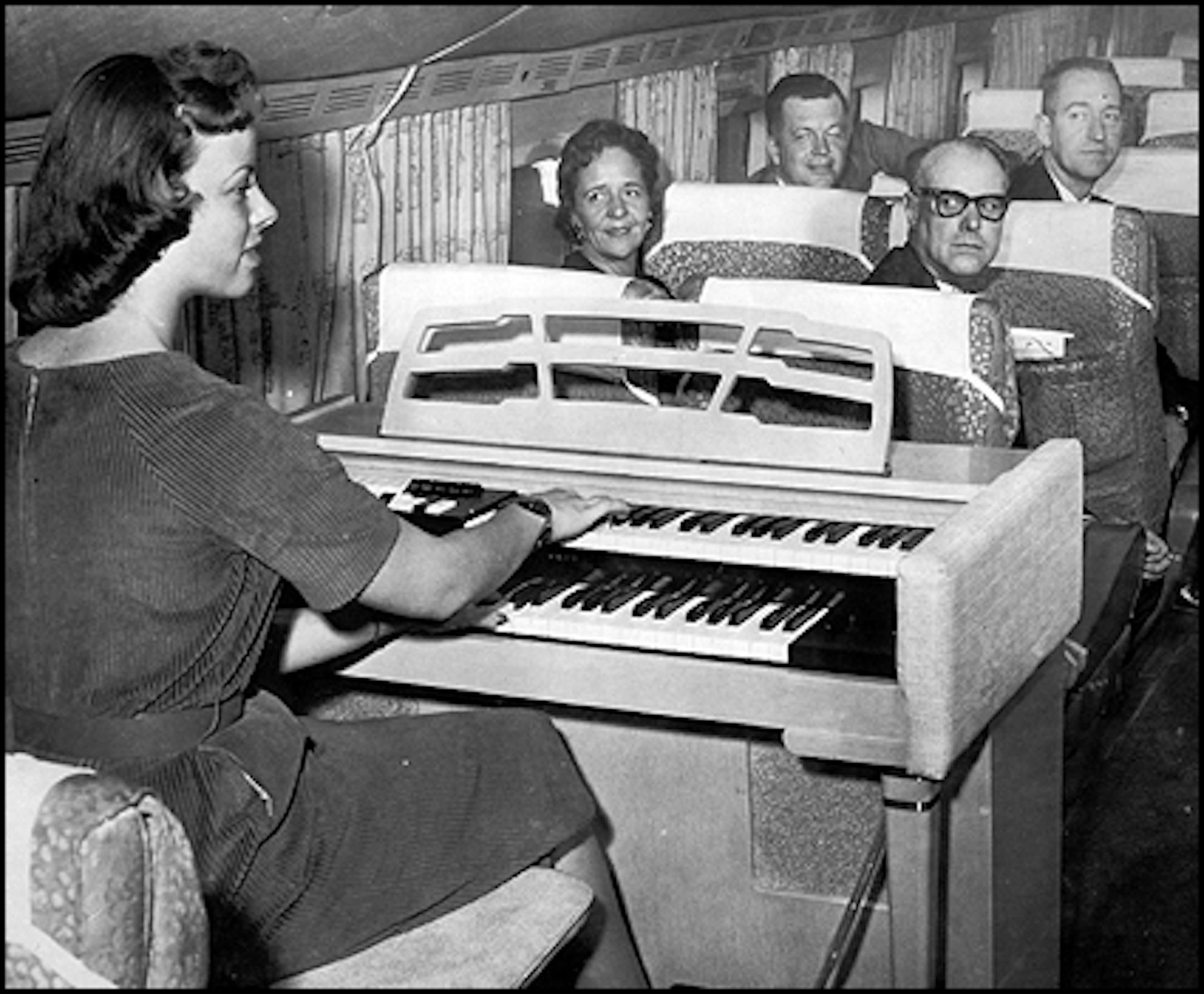 1959: Organist Nan Bergin serenades NWA passengers