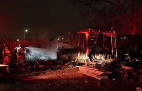 An early morning fire raced through a homeless encampment along I-94, near Cretin Ave., destroying several tents and a parked RV Monday in St. Paul.