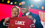 North Dakota State quarterback Trey Lance, right, holds a jersey with NFL Commissioner Roger Goodell after being chosen by the San Francisco 49ers wit