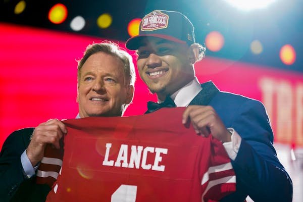 North Dakota State quarterback Trey Lance, right, holds a jersey with NFL Commissioner Roger Goodell after being chosen by the San Francisco 49ers wit