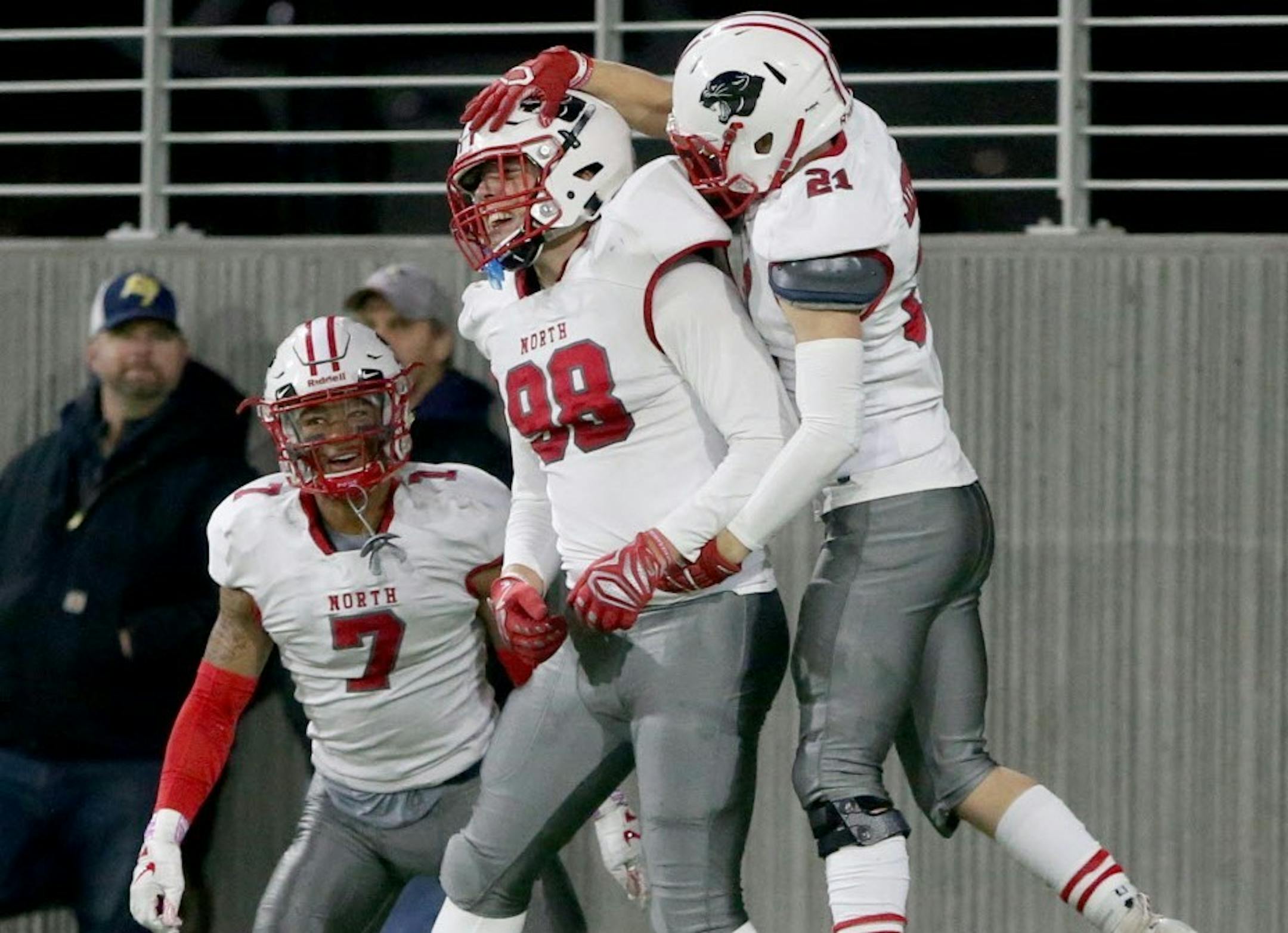 Lakeville linebacker Eli Mostaert (98) celebrates his interception for a TD against Prior Lake with teammates Thomas Jensen (21) and RaJa Nelson (7) during the first half Friday, Oct. 12, 2018, at TCO Stadium in Eagan, MN.]