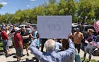A man holds up a sign against Critical Race Theory during a protest outside a Washoe County School District board meeting on May 25, in Reno, Nev. 