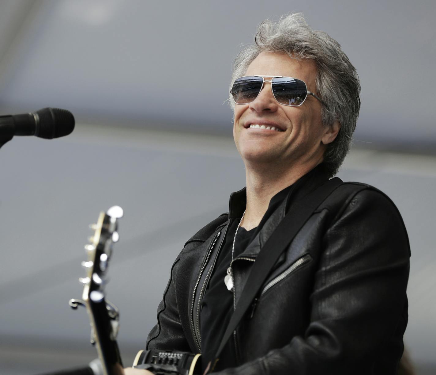 Musician Jon Bon Jovi performs during a surprise appearance at the Fairleigh Dickinson University commencement ceremony, Tuesday, May 16, 2017, at MetLife Stadium in East Rutherford, N.J. The school won a nationwide contest to bring the New Jersey-based band Bon Jovi to play their graduation by generating the most interest on social media. (AP Photo/Julio Cortez)