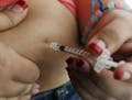 FILE - In this April 29, 2012 file photo, a woman diagnosed with diabetes gives herself an injection of insulin at her home in the Los Angeles suburb 
