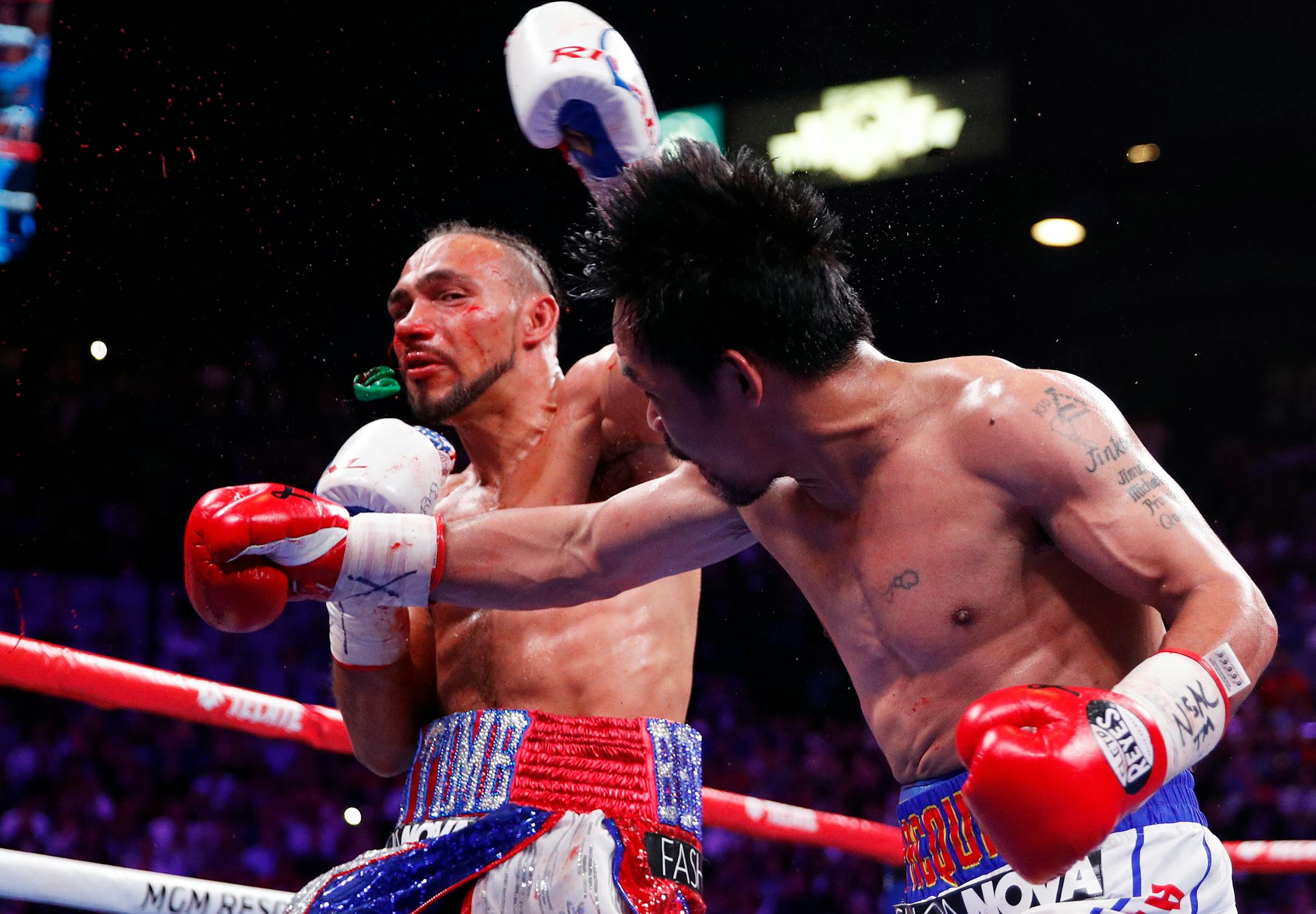 Manny Pacquiao punched the mouthpiece from Keith Thurman during the fifth round of a welterweight title fight Saturday in Las Vegas.
