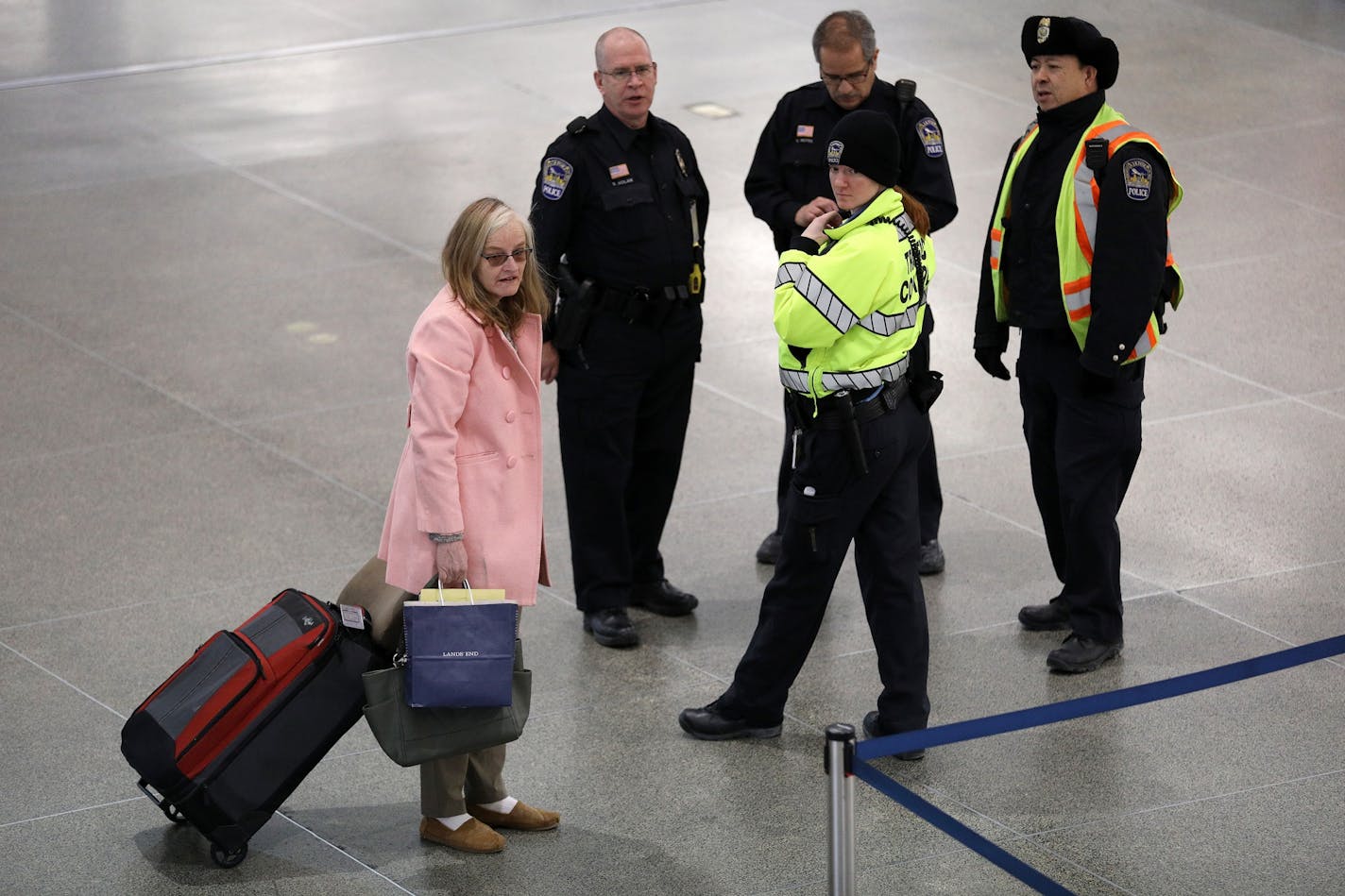 A traveler asks directions from a group of police officers Saturday.