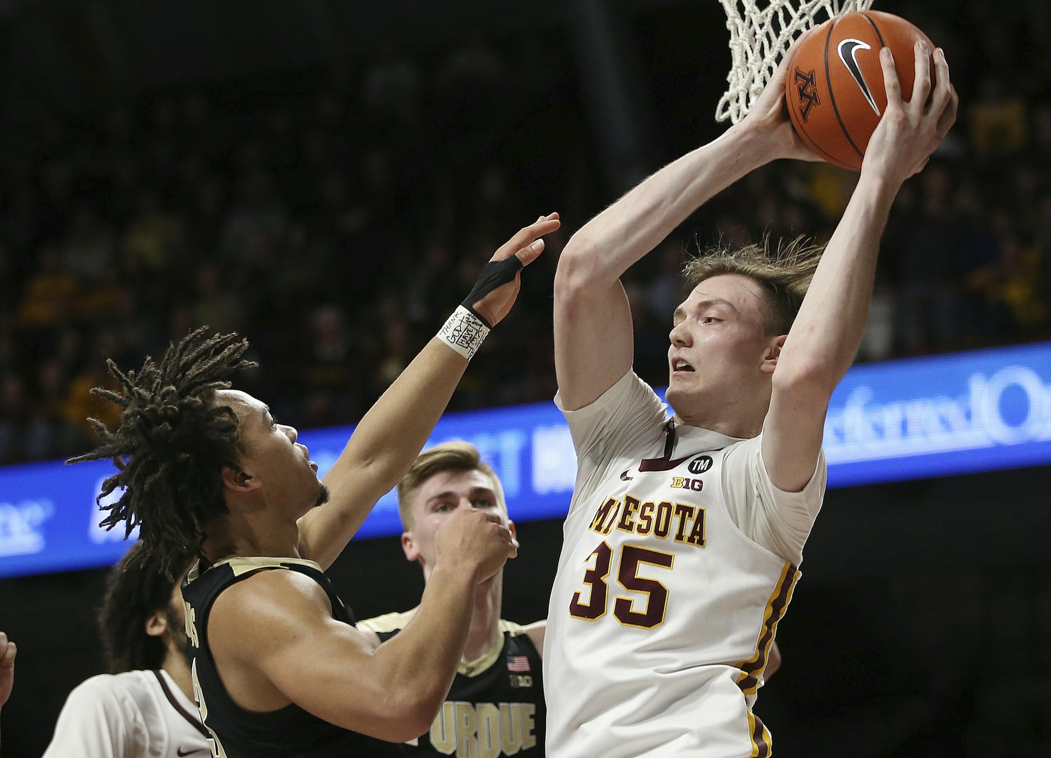 Minnesota's center Matz Stockman, right, rebounds against Purdue's Carsen Edwards, left, during the second half of an NCAA basketball game Tuesday, March 5, 2019, in Minneapolis. Minnesota won 73-69. (AP Photo/Stacy Bengs)