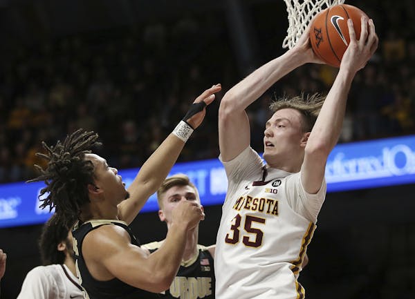 Minnesota's center Matz Stockman, right, rebounds against Purdue's Carsen Edwards, left, during the second half of an NCAA basketball game Tuesday, Ma