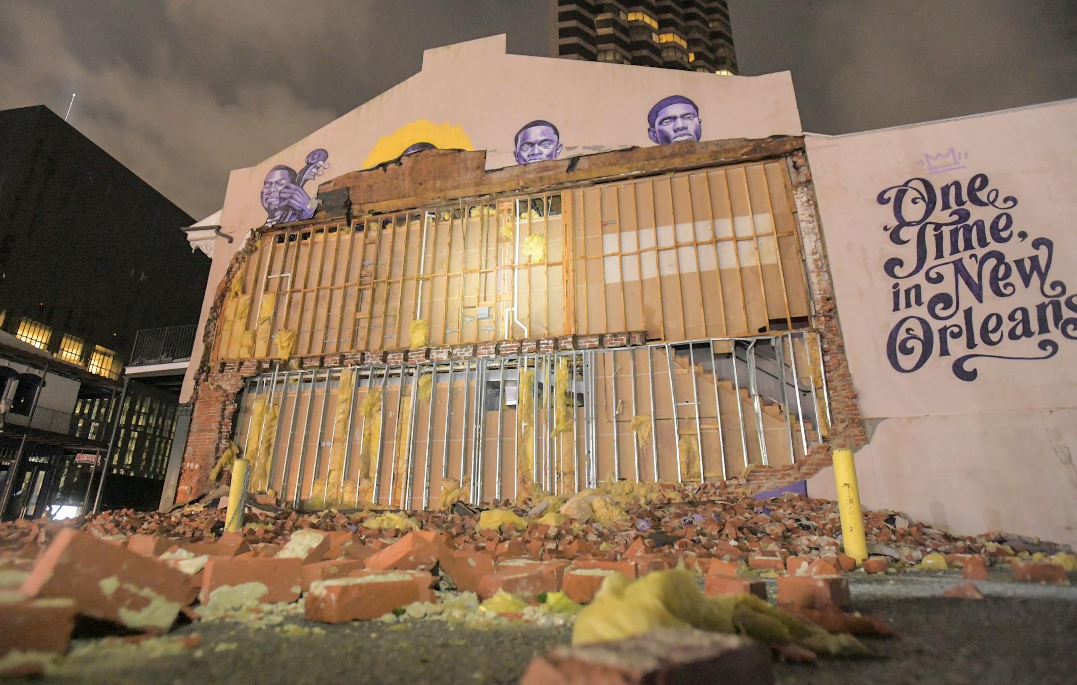 The remains of the Buddy Bolden mural on the wall of The Little Gem Saloon are seen on S. Rampart St. in New Orleans, La., early Monday, Aug. 30, 2021. Hurricane Ida became a tropical storm as its top winds slowed over Mississippi on Monday, while across southeast Louisiana residents waited for daylight to be rescued from floodwaters and see how much damage was caused by one of the most powerful hurricanes ever to strike the U.S. mainland. All of New Orleans lost power right around sunset Sunday, leading to an uneasy night of pouring rain and howling winds. (Max Becherer/The Advocate via AP)