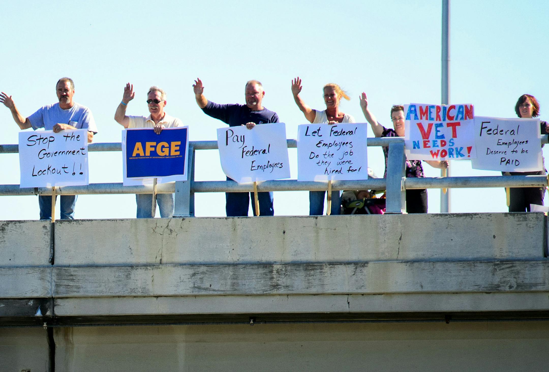 Federal workers and members of AFGE stodd on the 34th Avenue overpass of Highway 62 over the lunch hour to draw attention to how federal workers and those they care for will be affected by the government shutdown, Tuesday, October 1, 2013 ] GLEN STUBBE * gstubbe@startribune.com