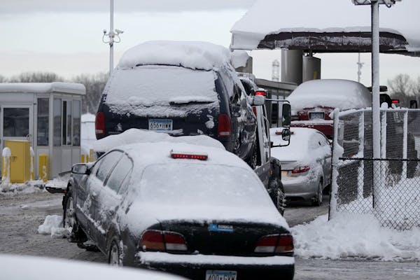 Dec. 10, 2012: Tow trucks loaded with cars made their way into the Minneapolis Impound lot.