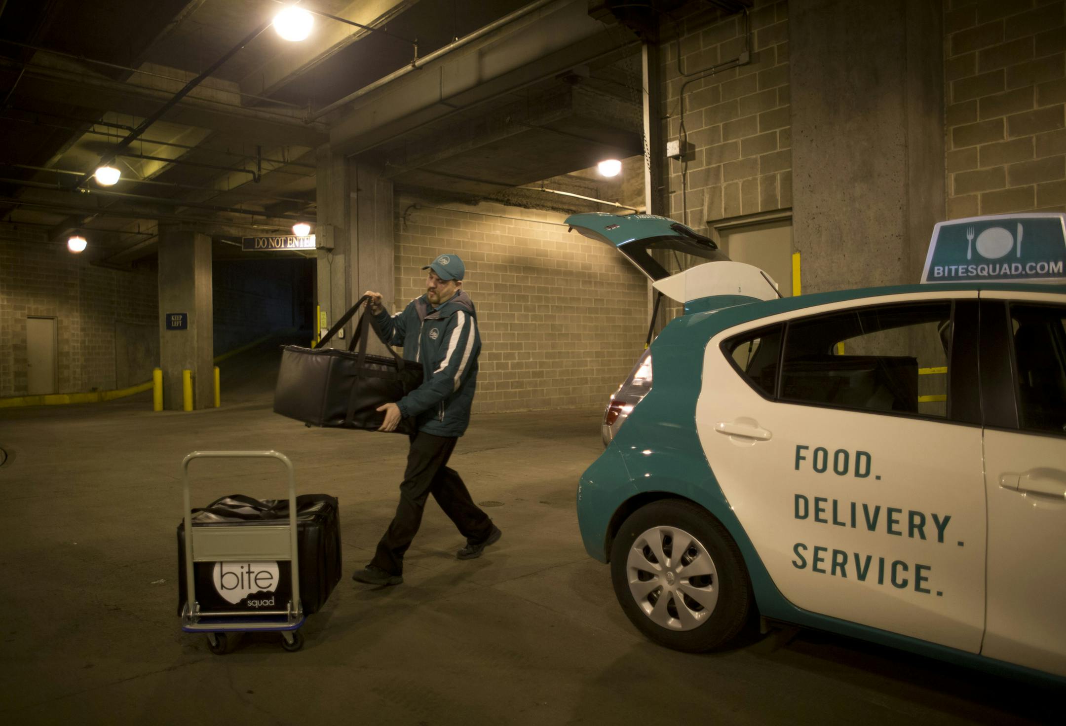 Restaurants are now outsourcing one of their onerous tasks, delivery. With food as a primary focus, restaurants can leave the delivery to a 3rd party. At least six delivery services have sprung up in the Twin Cities in the past year. Sean Dolan, a delivery driver for one of the new ones, Bite Squad, unloaded a large order of Mexican food from Pancho Villa's Bar & Grill that he was delivering at a downtown Minneapolis office building Thursday afternoon, April 4, 2013. ] JEFF WHEELER ‚Ä