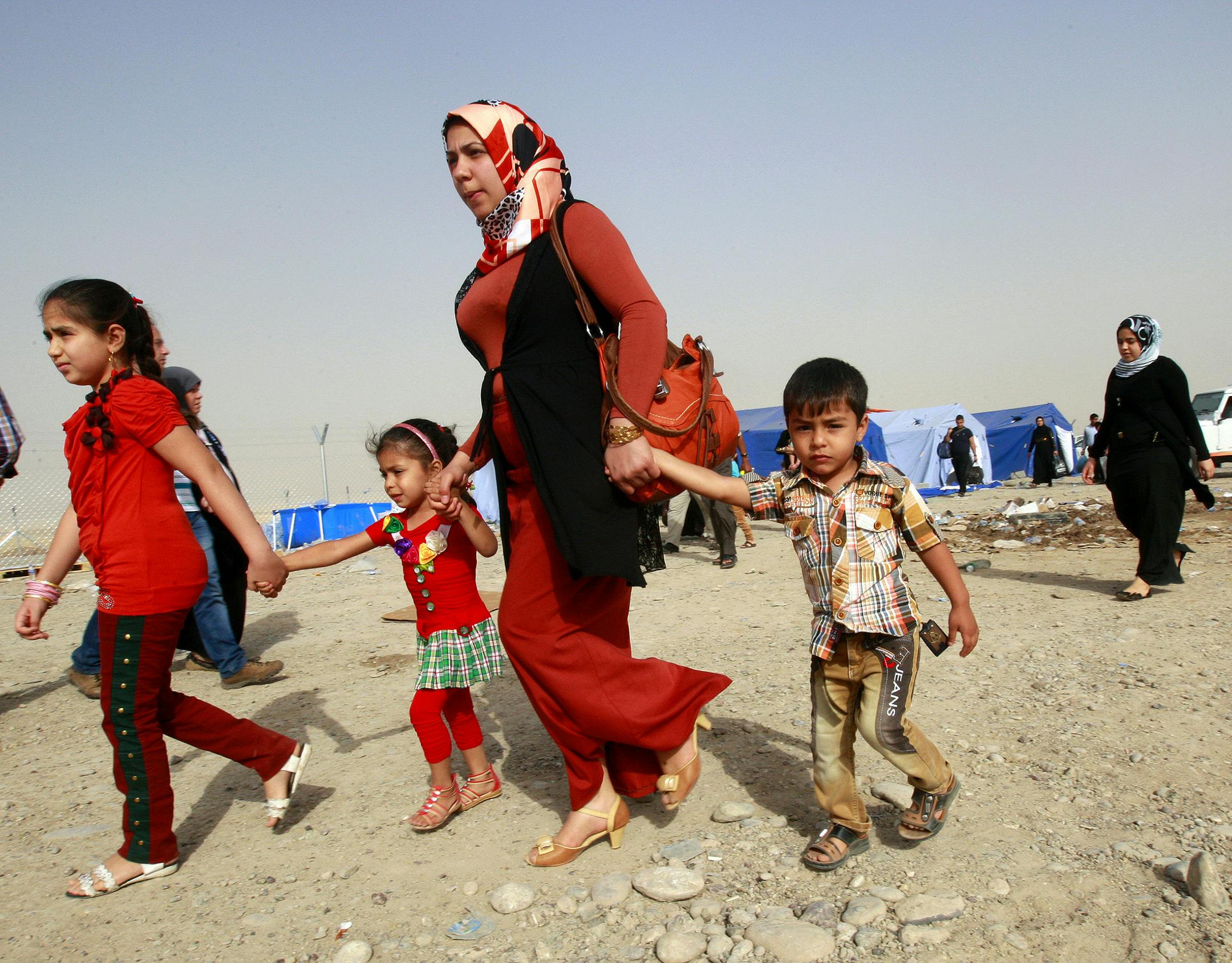 Refugees fleeing from Mosul head to the self-ruled northern Kurdish region in Irbil, Iraq, 217 miles north of Baghdad, Thursday, June 12, 2014. The Islamic State of Iraq and the Levant, the al-Qaida breakaway group, on Monday and Tuesday took over much of Mosul in Iraq and then swept into the city of Tikrit further south. An estimated half a million residents fled Mosul, the economically important city.