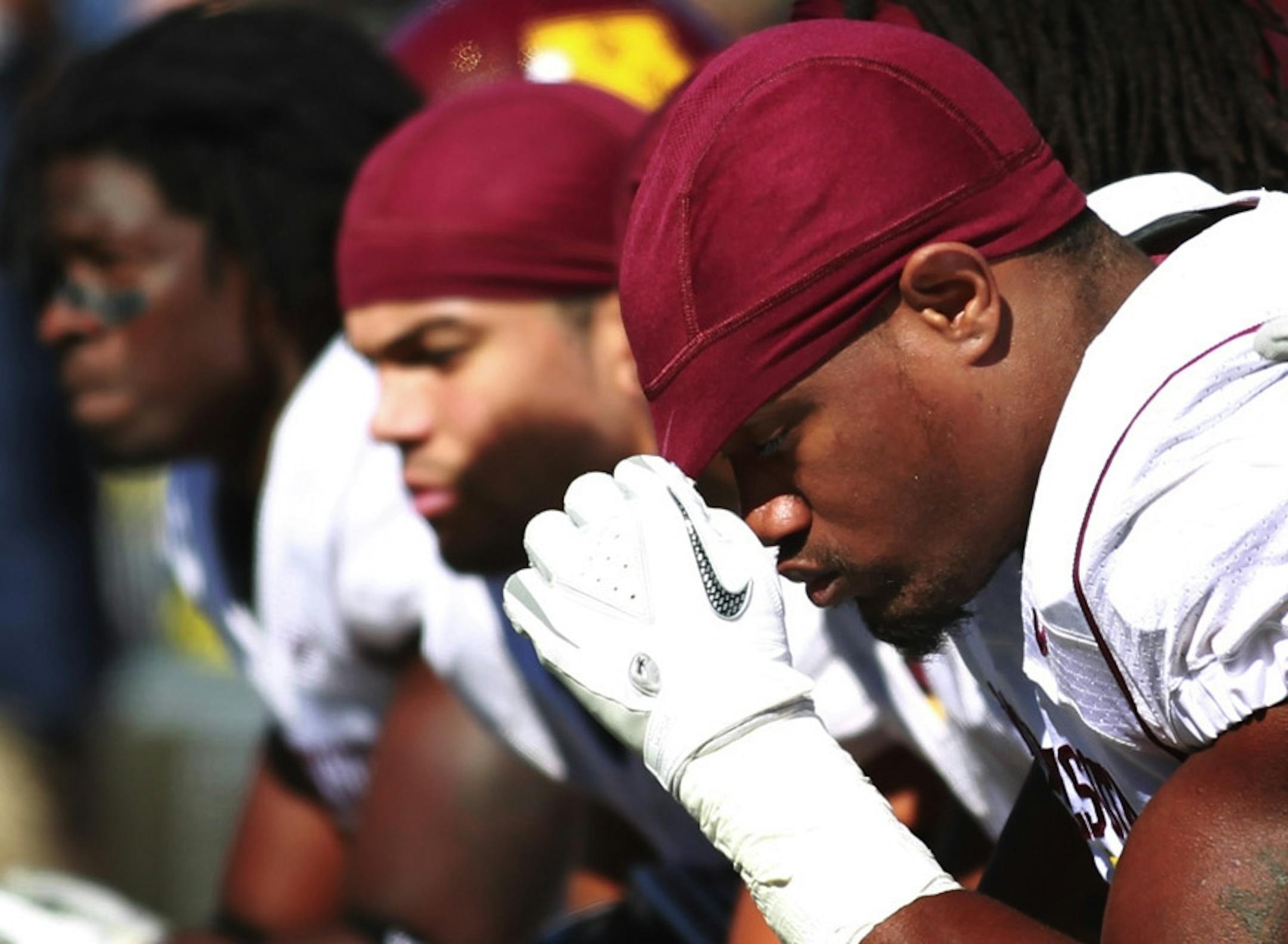 Minnesota linebacker coach Bill Miller looks over the bench as linebacker Keanon Cooper dropped his head late in the fourth quarter. Michigan beat Minnesota 58-0 during BigTen match up between the University of Minnesota and Michigan Saturday at Michigan Stadium in Ann Arbor, Michigan .