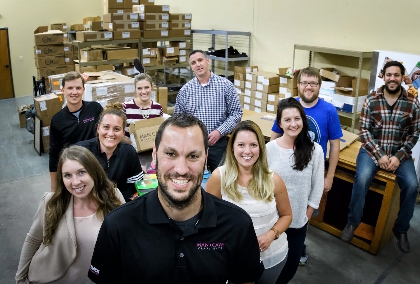 MAN CAVE CRAFT EATS FOUNDER AND CEO NICK BESTE with his team, clockwise from Nick in front, Haley Newhall, Christy Kramer, Benjamin Collins, Lindsay Schmidt, Brad Thornton, Taylor Mulfinger, Josh Beste, Chelsea Schulz and Dana Wais.