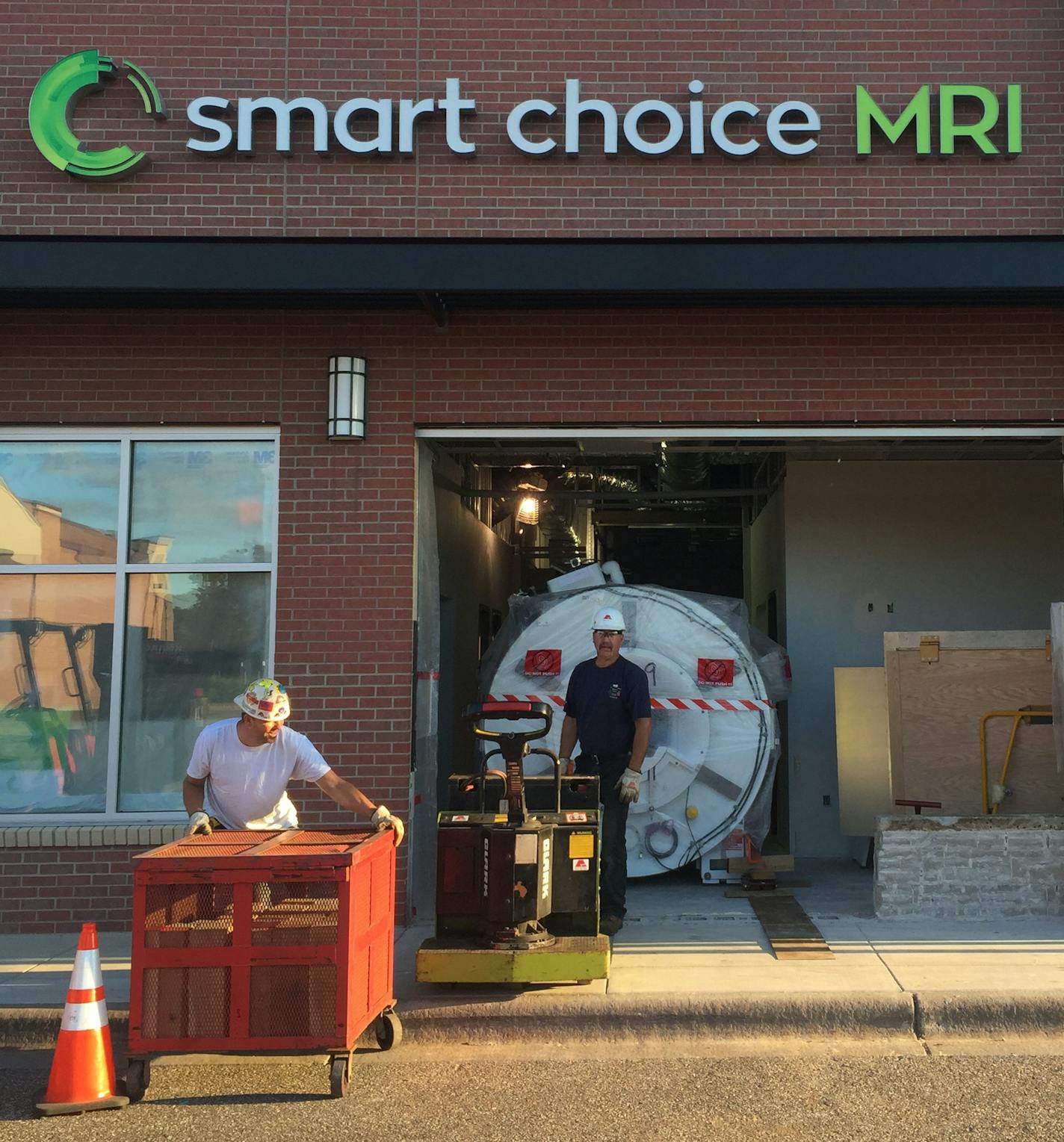 Workers move a1.5T GE Signa Explorer MRI into Smart Choice MRI location in Woodbury on Sept. 1.