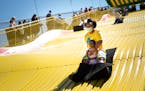 Shawnda Henderson, of Minneapolis, rode the Giant slide with her daughter Mira on the last day of the Kickoff to Summer at the Fair event in May at th