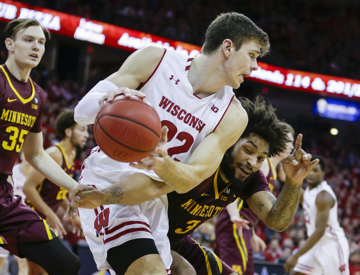 Minnesota's Jordan Murphy (3) reaches in on Wisconsin's Ethan Happ (22) during the second half of an NCAA college basketball game Thursday, Jan. 3, 2019, in Madison, Wis. Minnesota won 59-52. (AP Photo/Andy Manis)