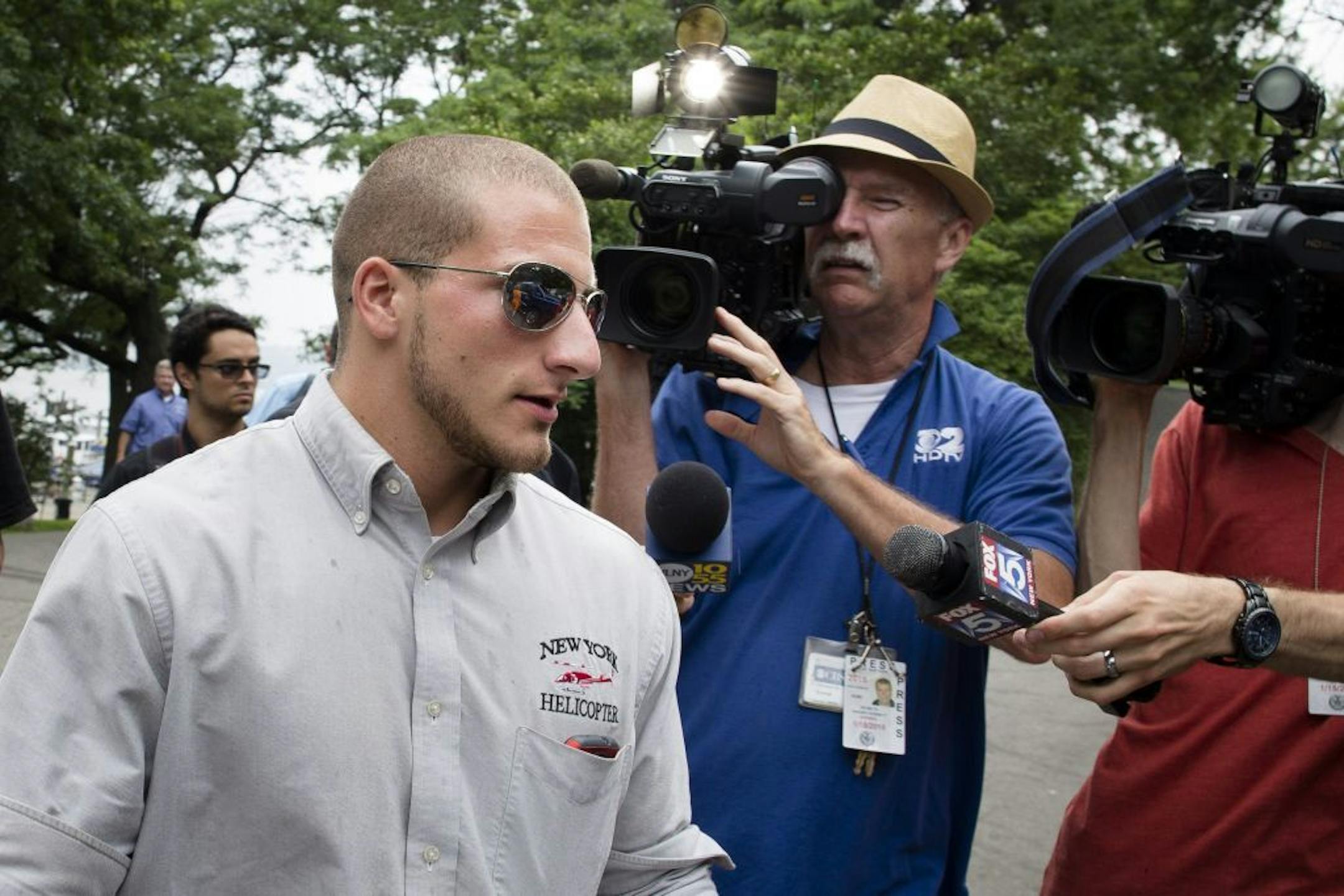 The helicopter pilot that made an emergency landing in the Hudson River leaves the 79th Street Boat Basin, Sunday, June 30, 2013, in New York. The charter helicopter was carrying a family of four Swedes on a sightseeing tour of New York City when it lost power shortly after takeoff and made an emergency landing on the Hudson River, authorities said. The pilot and occupants were uninjured.