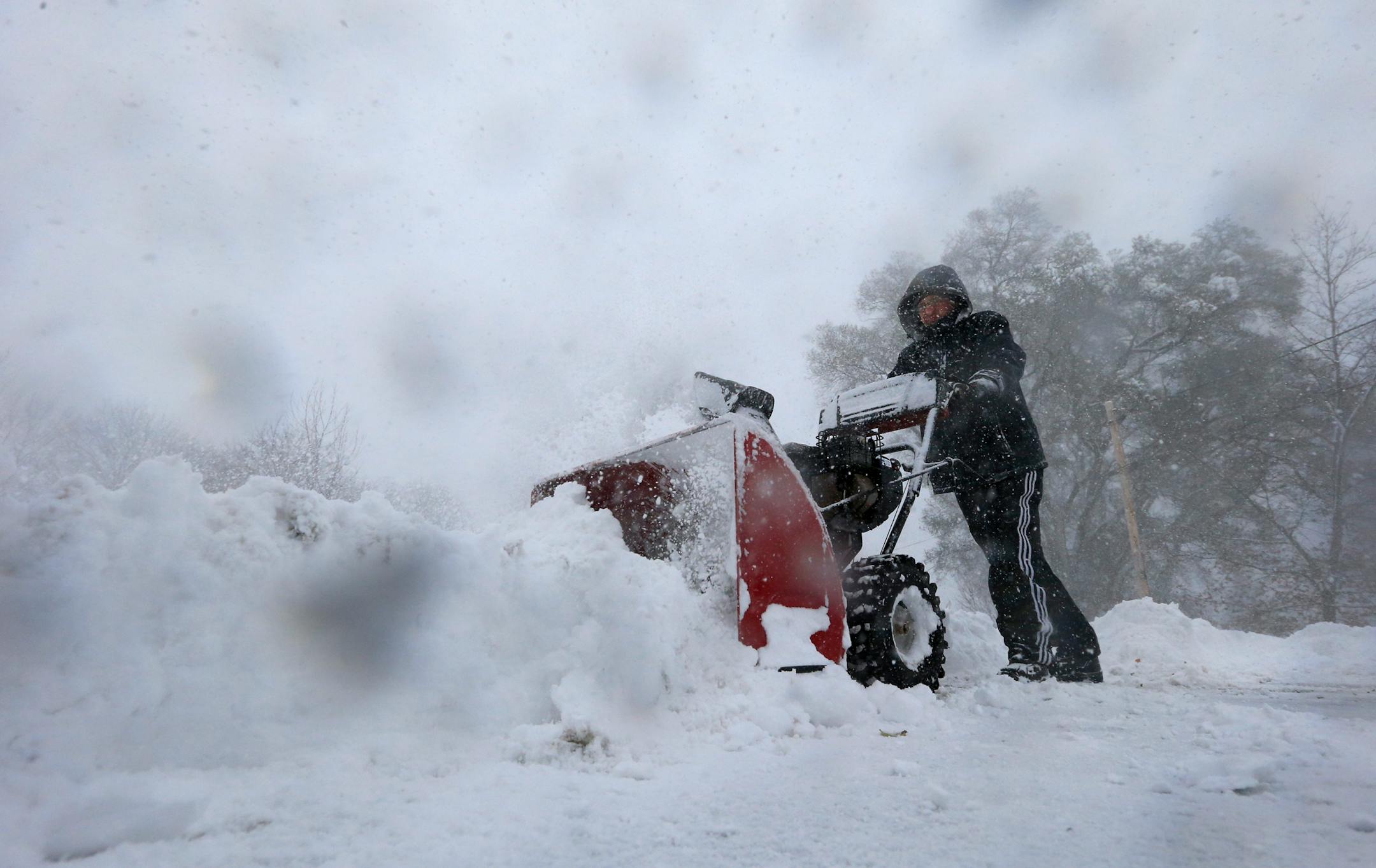 Chris Boettcher clears snow along Rt. 391 in Boston, N.Y., Tuesday, Nov. 18, 2014. Parts of New York measured the season's first big snowfall in feet, rather than inches, on Tuesday as 3 feet of lake-effect snow blanketed the Buffalo area and forced the closure of a 132-mile stretch of the state Thruway. (AP Photo/The Buffalo News, Harry Scull Jr.) TV OUT; MAGS OUT; MANDATORY CREDIT; BATAVIA DAILY NEWS OUT; DUNKIRK OBSERVER OUT; JAMESTOWN POST-JOURNAL OUT; LOCKPORT UNION-SUN JOURNAL OUT; NIAGARA