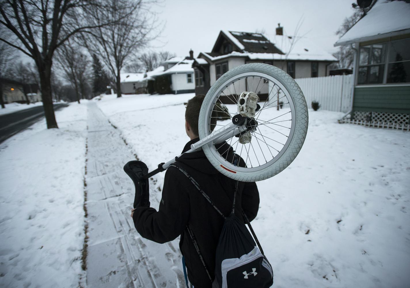 Twin Cities Unicyclists Club member Ben Hugo walked from his home to St. Matthew's Church in Columbia Heights for a night of unicycle hockey on Sunday, Jan. 24, 2016. ] (AARON LAVINSKY/STAR TRIBUNE) aaron.lavinsky@startribune.com Minneapolis is home to some of the best unicyclists in the world. Who knew? Meet the zany members of the Twin Cities Unicyclists Club who practice year-round - playing unicycle hockey and basketball, juggling, unicycle racing and more. We photograph the club during a ni