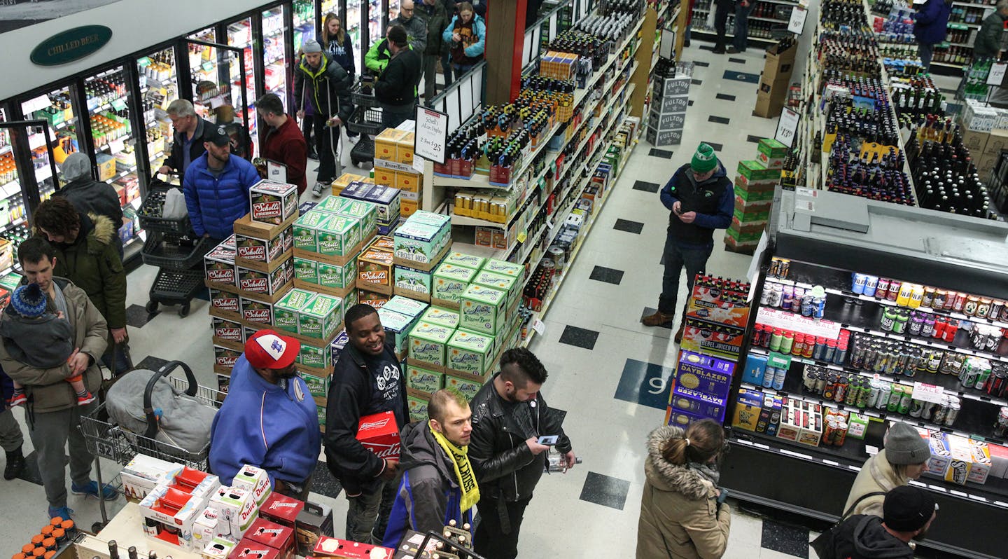 The line is wrapped all the way around the inside of the Surdyk's liquor store on Sunday. March 12, 2017. ] XAVIER WANG &#x2022; xavier.wang@startribune.com ORG XMIT: MIN1703121659570080