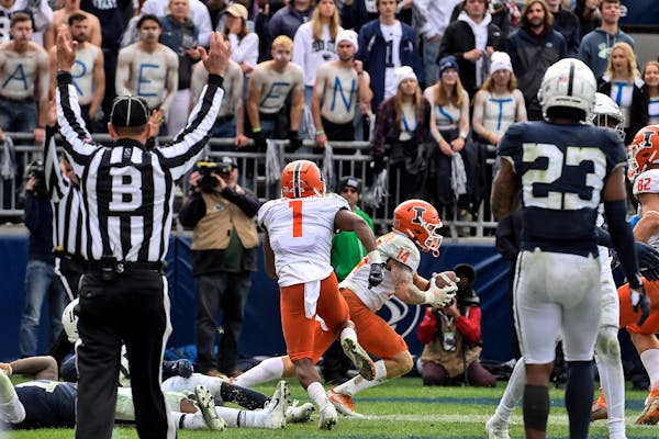 Illinois wide receiver Casey Washington (14) celebrated after a two-point conversion in the ninth overtime to defeat Penn State 20-18 last Saturday.