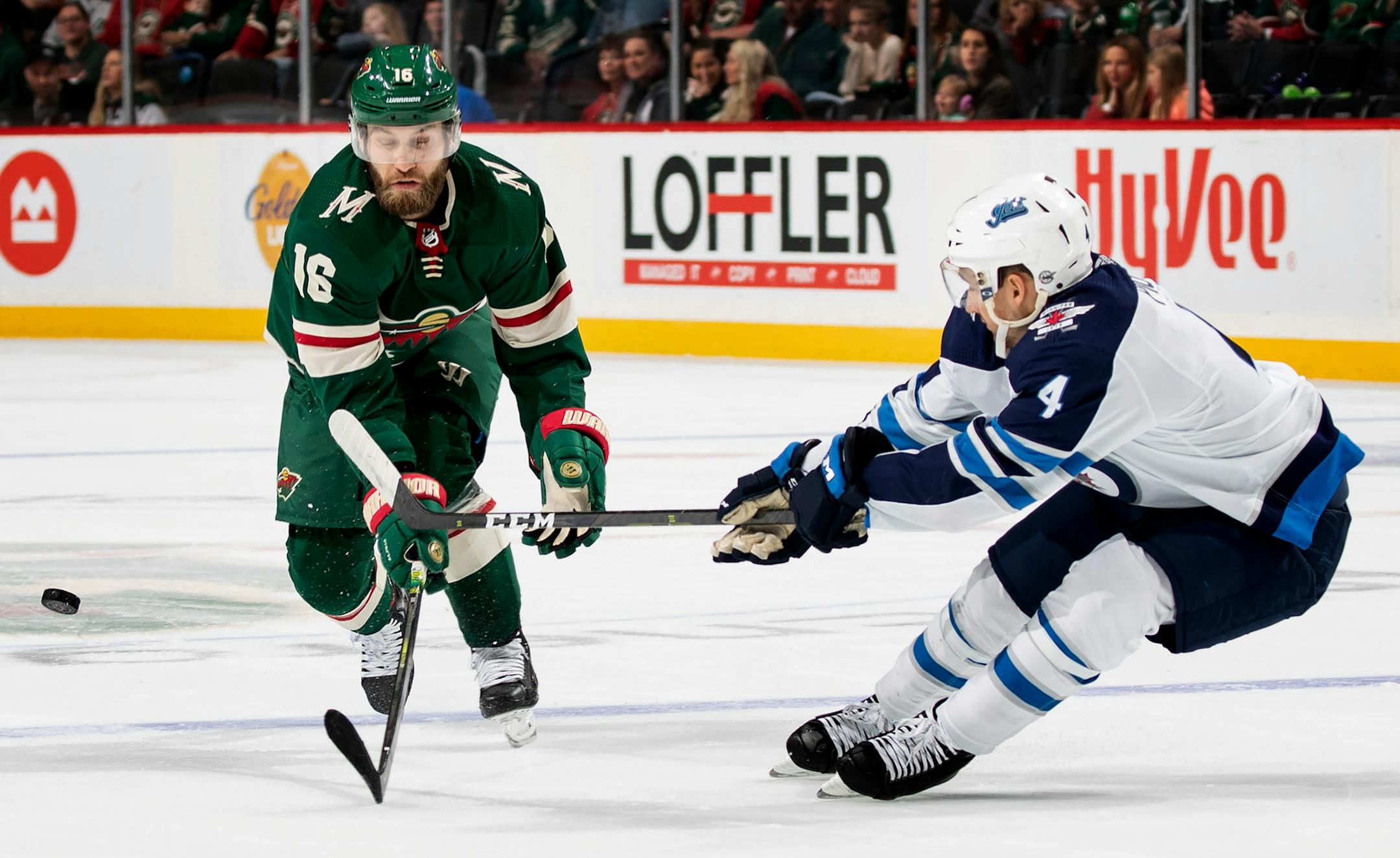 Jason Zucker of the Minnesota Wild (16) and Neal Pionk (4) of the Winnipeg Jets fought for a puck in the first period. ] CARLOS GONZALEZ • cgonzalez@startribune.com – St. Paul, MN – September 29, 2019, Xcel Energy Center, NHL Pre Season Hockey, Minnesota Wild vs. Winnipeg Jets