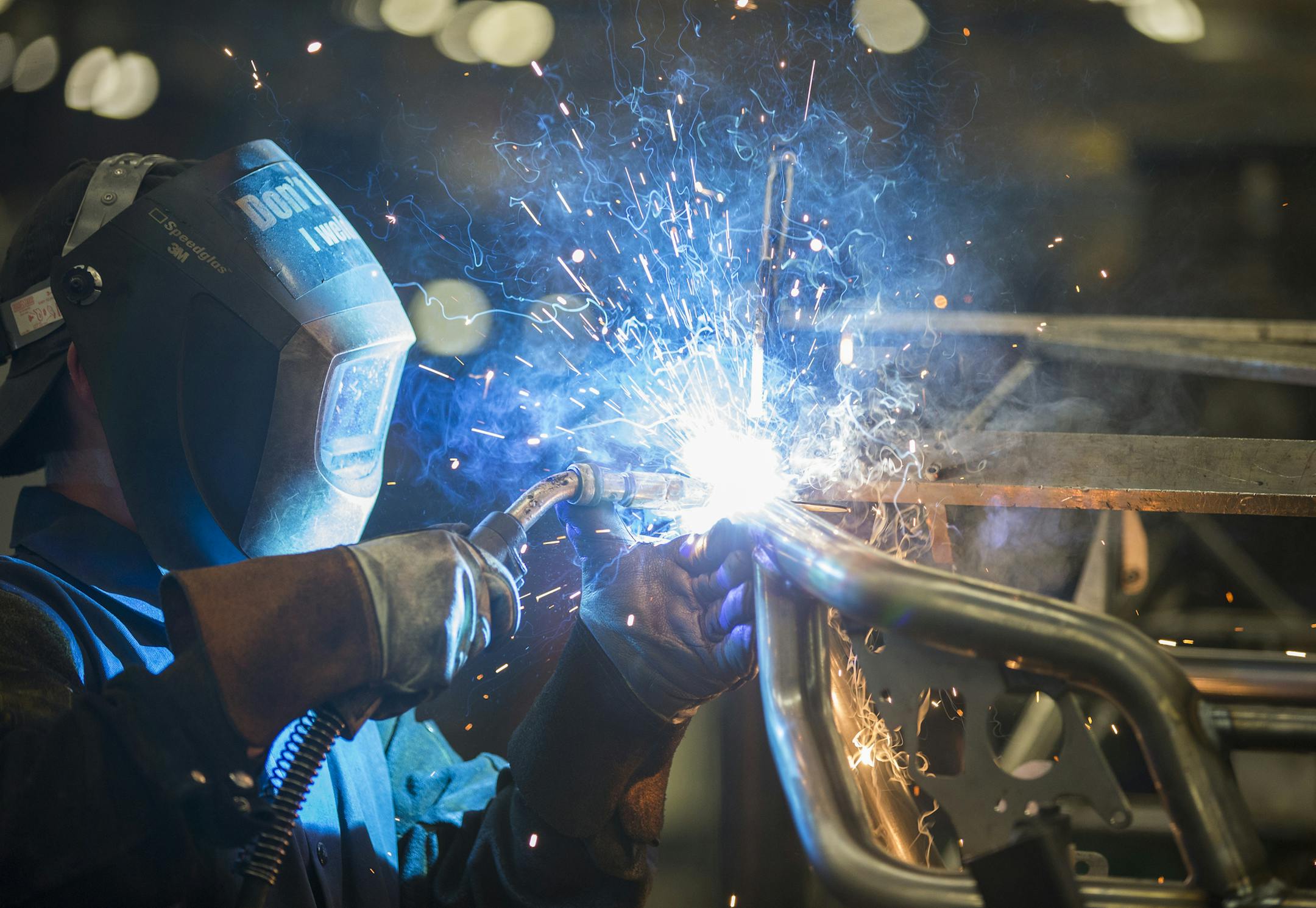 A worker welds the frame for the 2016 Wildcat X side-by-side vehicle in the Arctic Cat factory in Thief River Falls.