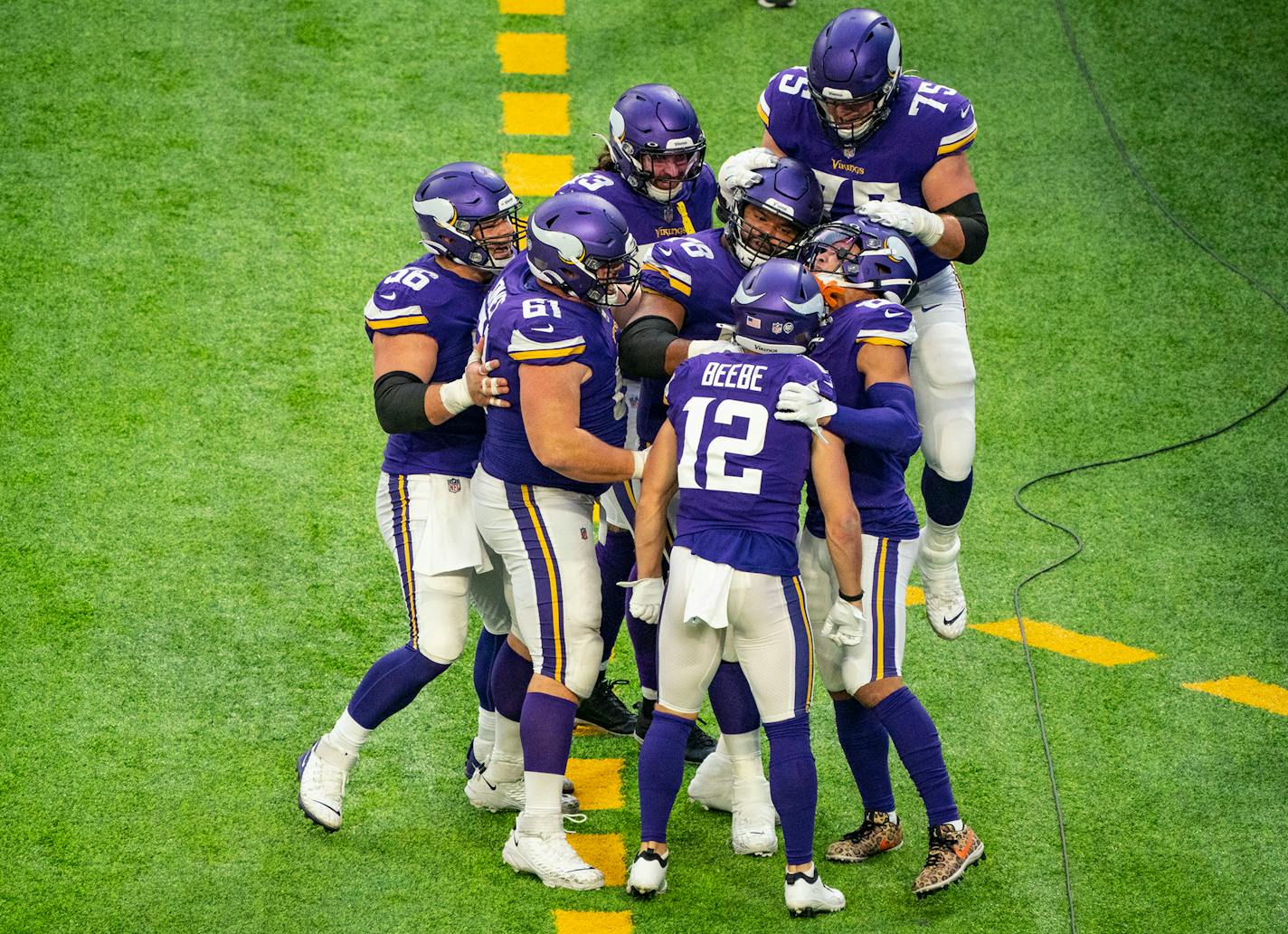 The Minnesota Vikings offense swarmed wide receiver Chad Beebe (12) after he scored the game winning touchdown with under a minute to play on Sunday. ]