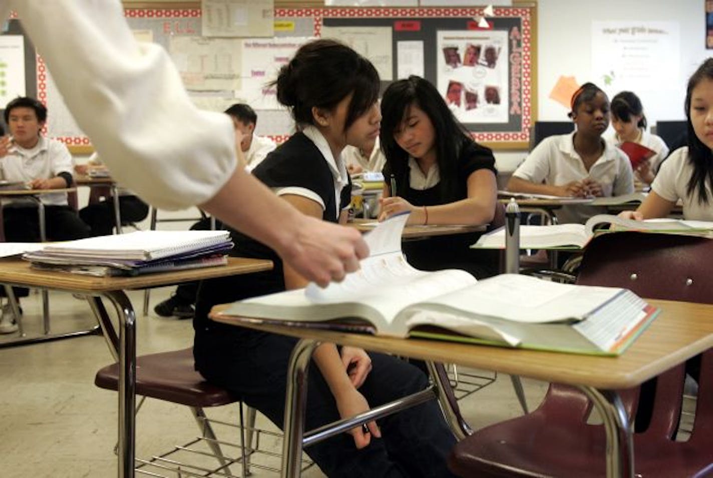 Eighth-grade geometry students, including Boa Xiong, center, follow along in the text with their teacher Angela Corbett while reviewing the pythagorean theorum and special triangles for comprehension before taking the real test.