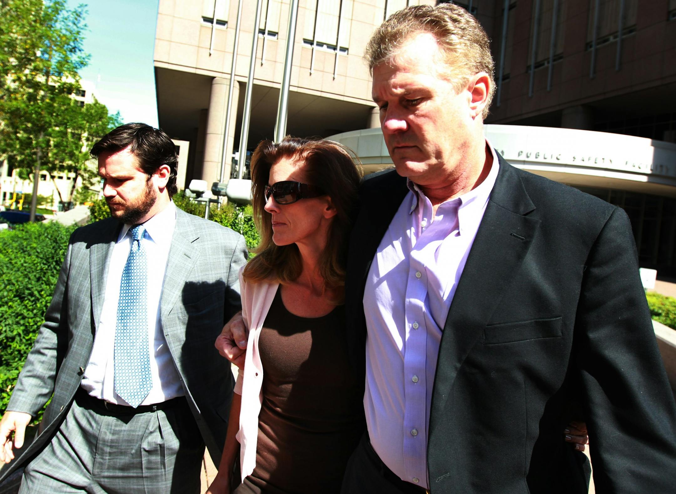 Flanked by her attorney Eric Nelson left, and husband Joe Senser Amy Senser walked out of the Hennepin County Jail in downtown Minneapolis Thursday September 15, 2011 after posting bond.