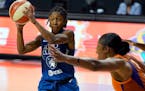Minnesota Lynx guard Crystal Dangerfield (2) passes off in front of Phoenix Mercury center Kia Vaughn (1) during the second half of a WNBA playoff bas