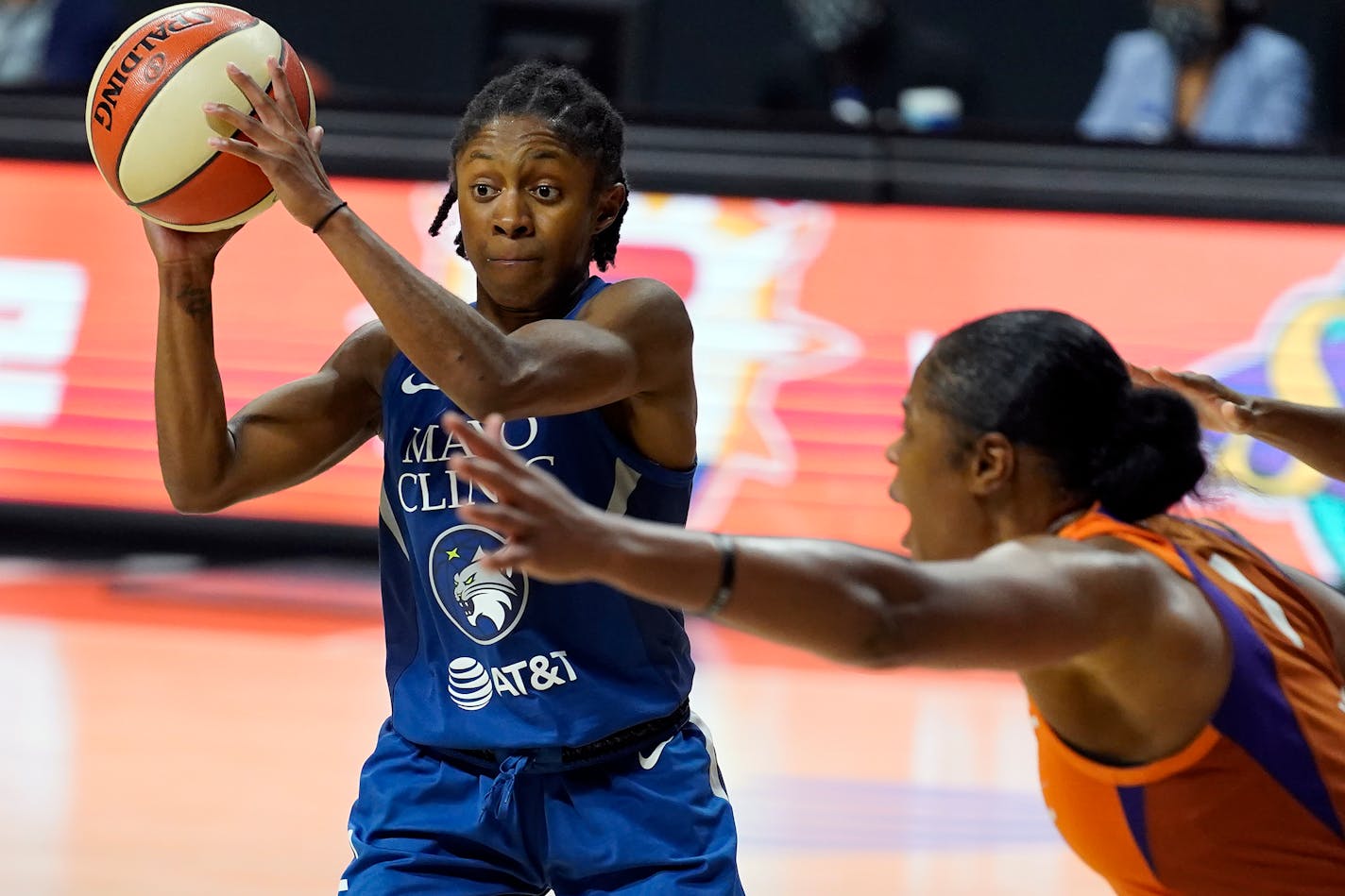 Minnesota Lynx guard Crystal Dangerfield (2) passes off in front of Phoenix Mercury center Kia Vaughn (1) during the second half of a WNBA playoff basketball game Thursday, Sept. 17, 2020, in Bradenton, Fla. (AP Photo/Chris O'Meara)