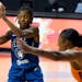 Minnesota Lynx guard Crystal Dangerfield (2) passes off in front of Phoenix Mercury center Kia Vaughn (1) during the second half of a WNBA playoff bas