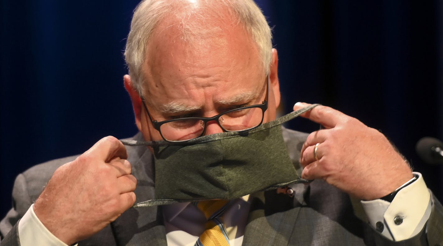 Minnesota Gov. Tim Walz donned his face mask at the end of a news conference in July.