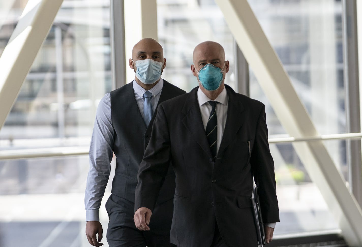 Former Minneapolis police officer J. Alexander Kueng, left, arrives with his attorney Thomas Plunkett for a hearing at the Hennepin County Government Center in Minneapolis on July 21, 2020.