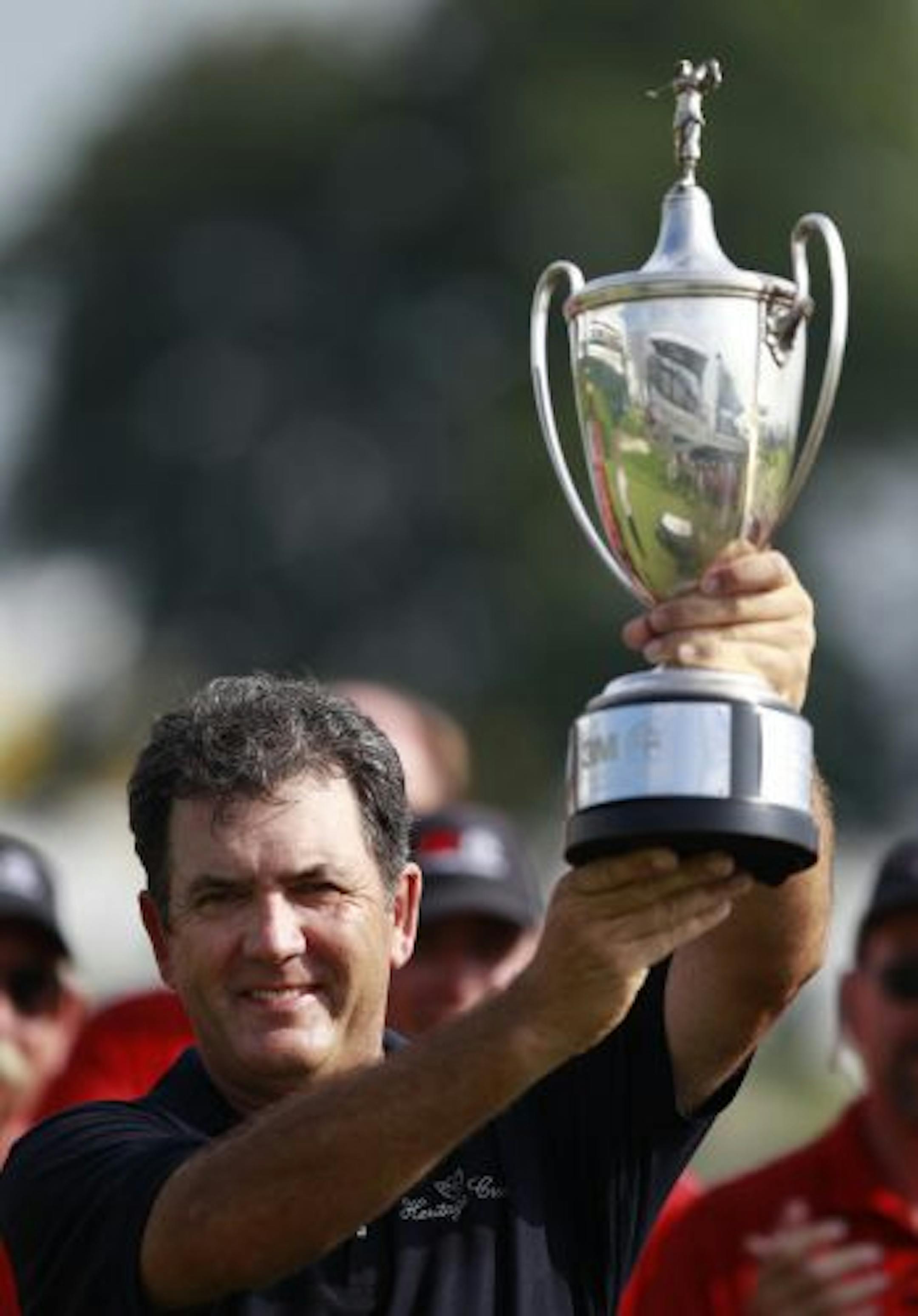 David Frost raised the 3M Championship trophy and also raised a glass of his own company's wine in celebration.