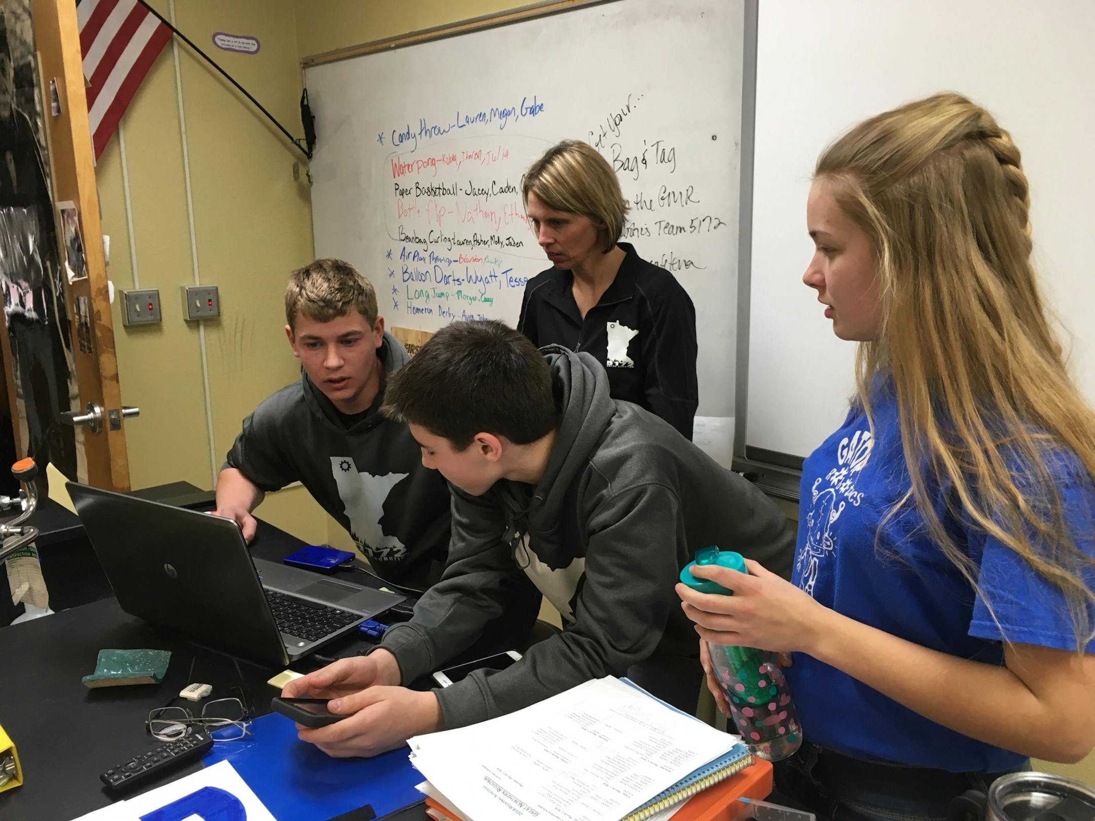 Members of the Greenbush-Middle River robotics team work out a problem as they refine their robot design.